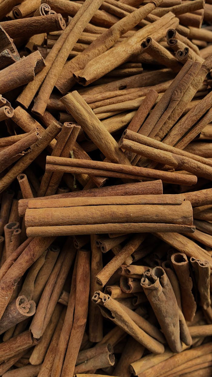 Close-up view of a pile of aromatic cinnamon sticks, perfect for culinary use.